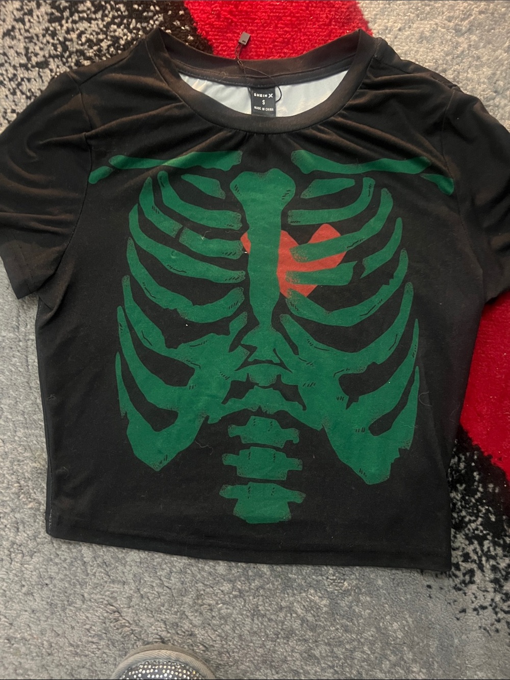 SHEIN Black Tee with Green Ribcage and Red Heart Accent